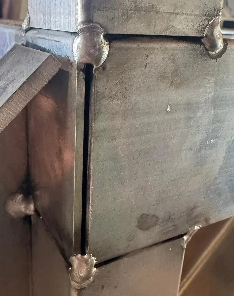 Close-up aluminum weld joint during fabrication process