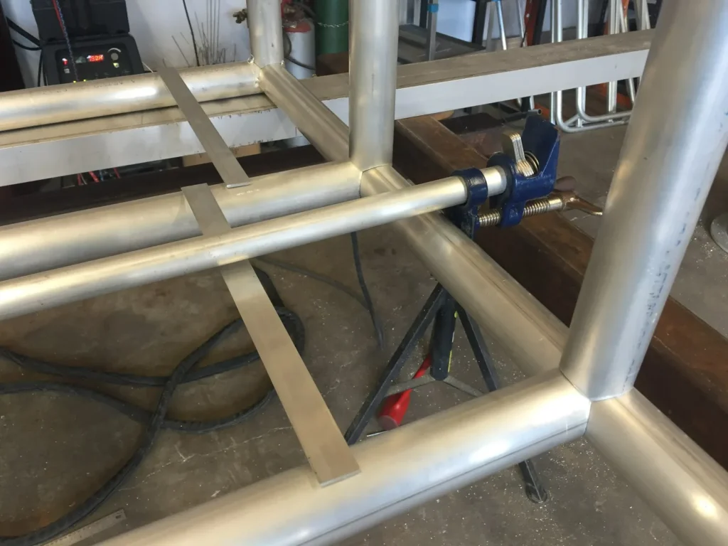 Aluminum pipe frame welded with brackets for custom fabrication project